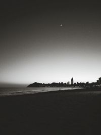 Scenic view of beach against clear sky