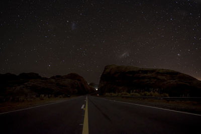 Road against sky at night