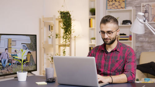 Young man using laptop at home