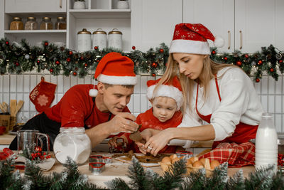 Christmas bakery. family making gingerbread, christmas and new year traditions concept