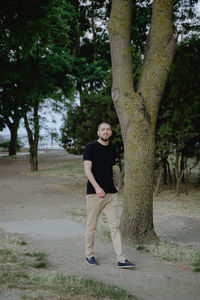 Full length of woman standing in forest