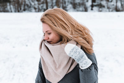 Young woman standing on snow