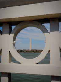 Close-up of railing against sky seen through window