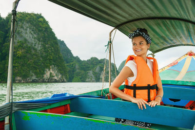 Portrait of young woman sitting in boat