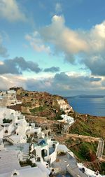 High angle view of townscape by sea against sky