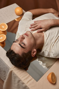 Portrait of man lying on table