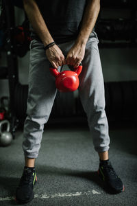 Attractive young athlete doing workout with kettlebell