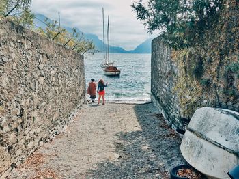 Rear view of people enjoying at sea shore