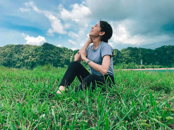 Young man sitting on field