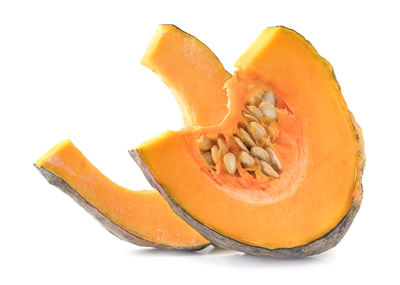 Close-up of orange fruit against white background