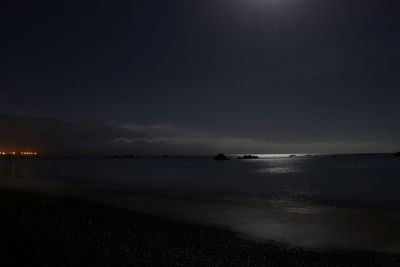 Scenic view of sea against sky at night