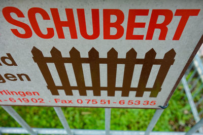 Close-up of warning sign on fence