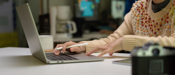 Midsection of woman working at desk