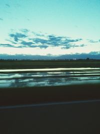 Scenic view of landscape against cloudy sky