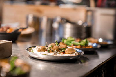 Close-up of delicious focaccia served in plate on kitchen counter at restaurant