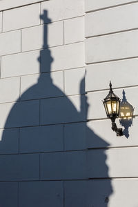 Shadow of street light on building wall