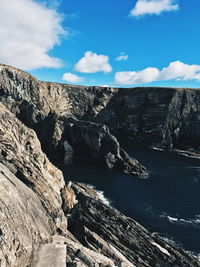 Scenic view of rocks in sea against sky