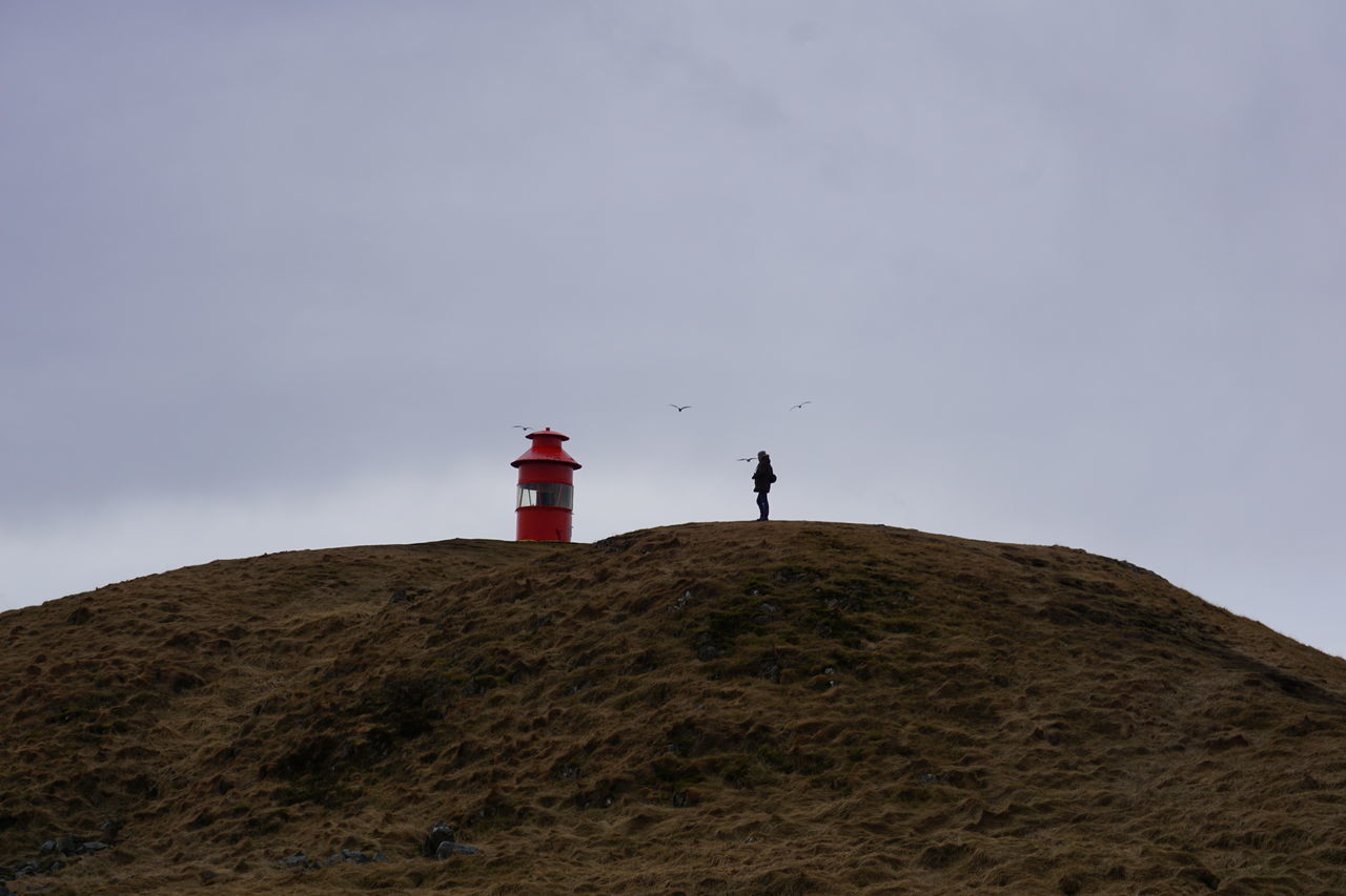 LOW ANGLE VIEW OF LIGHTHOUSE ON BUILDING AGAINST SKY