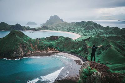 Man standing on mountain against sky