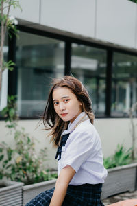 Portrait of a beautiful young woman standing outdoors