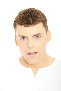 Portrait of smiling young man against white background