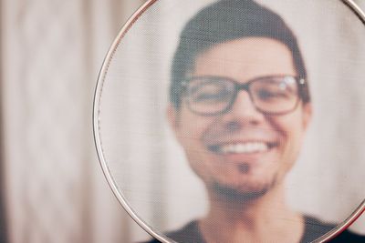 Portrait of smiling man seen through net