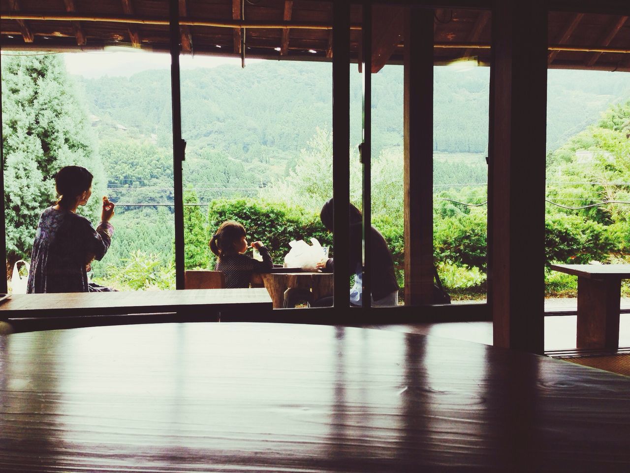 indoors, men, lifestyles, silhouette, sitting, leisure activity, rear view, person, built structure, water, window, architecture, looking at view, railing, full length, glass - material, standing