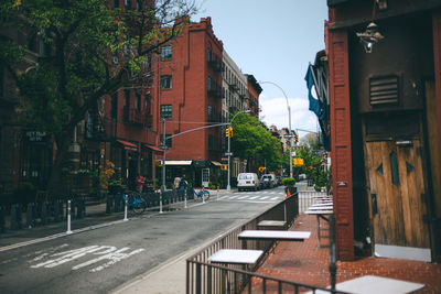 Road by buildings in city