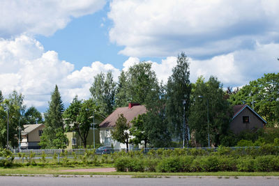 Houses and trees against sky