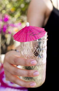 Cropped image of woman holding cocktail 