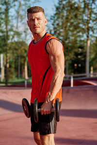 Portrait of young man exercising in gym
