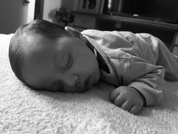 Cute baby sleeping on bed at home