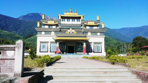Temple by mountains against clear sky