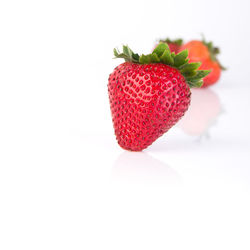 Close-up of strawberry over white background