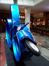 Blue car in illuminated city at night