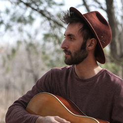 Young man playing guitar at park