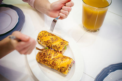 High angle view of person eating food in plate