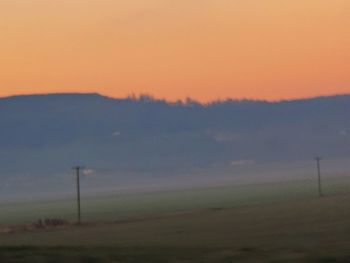 Scenic view of field against sky during sunset