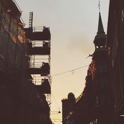 Low angle view of silhouette building against sky