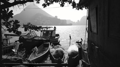 Boats moored on sea against sky