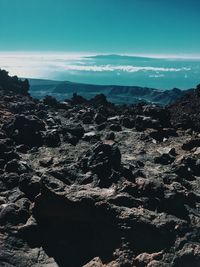 Aerial view of sea and rocks against sky