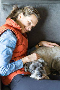 Charming girl is staying at home with a sleepy pup