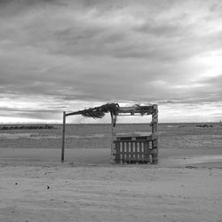 Lifeguard hut on beach against sky