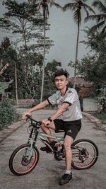 Portrait of smiling man riding bicycle