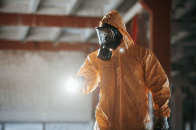 Rear view of man standing against wall