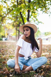 Portrait of a young woman sitting outdoors