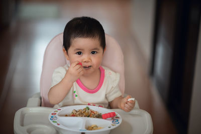 Portrait of cute girl eating food