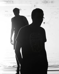 Silhouette couple standing at beach