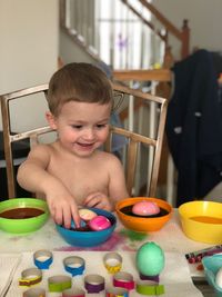 Cute smiling boy playing at home