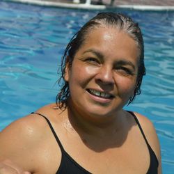 Portrait of smiling woman swimming in pool